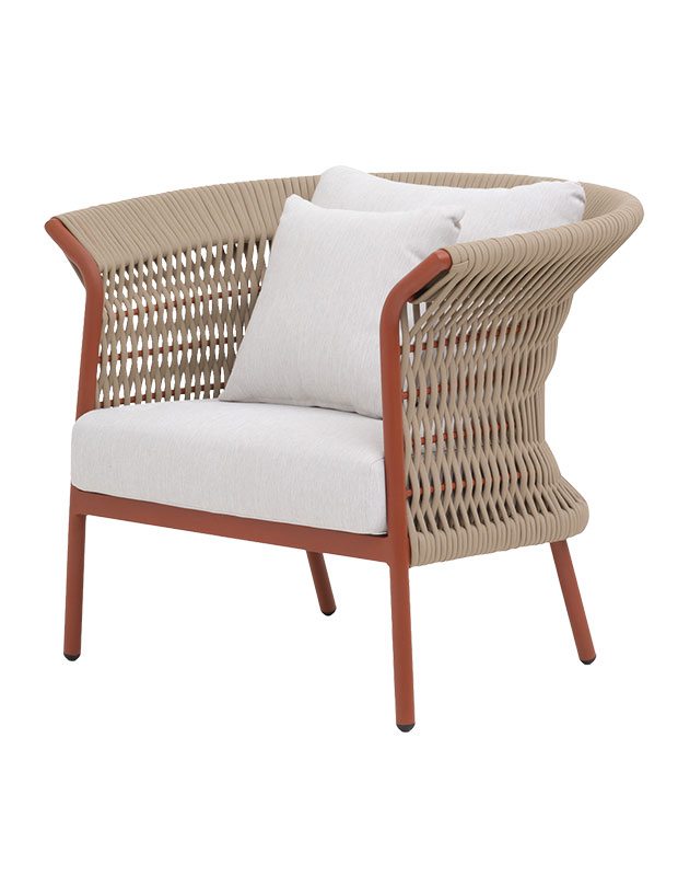 A woven outdoor chair with white cushions.