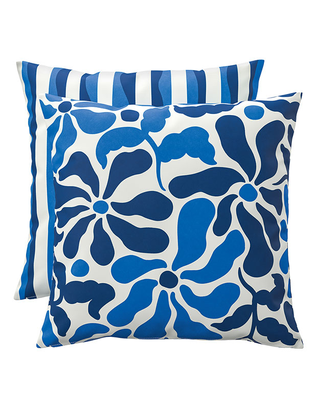 two pillows with blue print, one floral, one bold stripes.