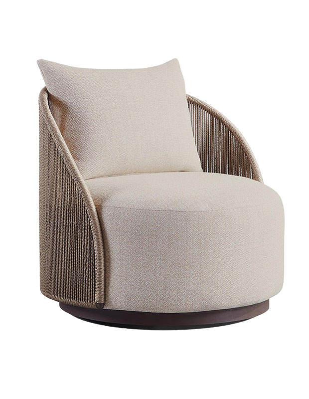 A rounded chair with cording around the sides and back, the rounded cushions are cream coloured.