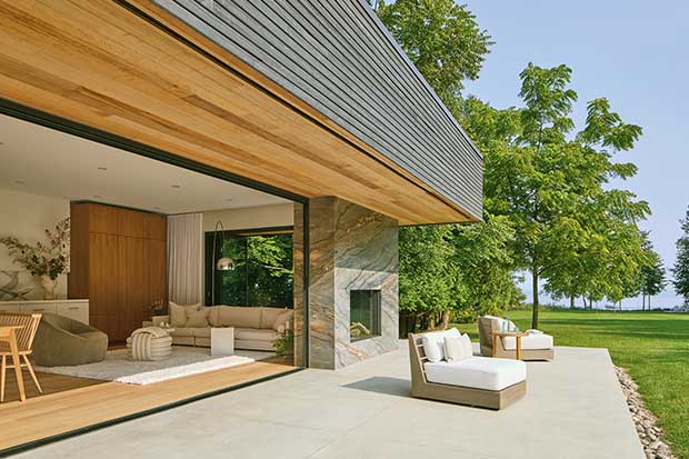 A large open pool house with lounge furniture and an open layout. unique backyard pools