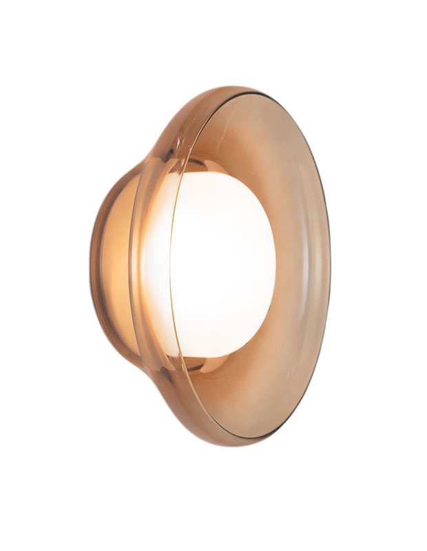 Calm, stylish accents: An image of a lightbulb in a tinted glass wall sconce on a white background.