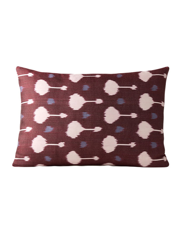 A photo of a red throw pillow with an abstract design in pink and grey on a white background. calm stylish accents