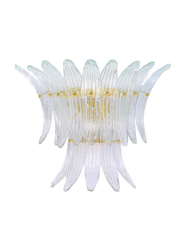 A photo of a statement sconce made of hanging pieces of clear glass in flower petal shapes.