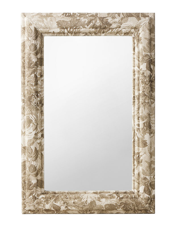 Calm, stylish accents: A photo of a mirror with a frame wrapped in forest-patterned fabric.