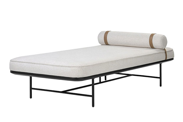 Calm, stylish accents: An image of a minimalistic lounger with white upholstery and black metal frame on a white background.