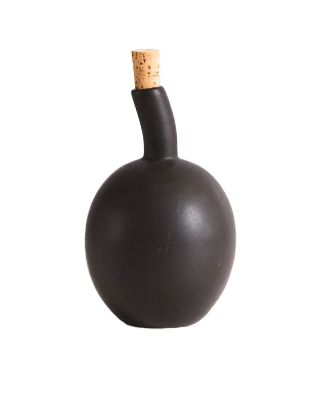 A photograph of a sustainable gift: A round, black decanter with a cork sticking out of its spout is pictured against a white background.