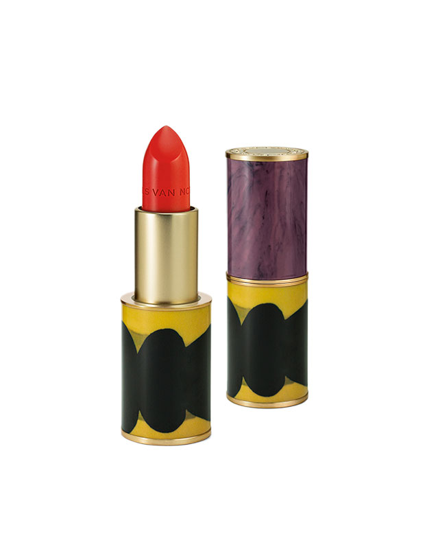 Photograph of a sustainable gift: Two tubes of lipstick sitting on end, one of them open to reveal a bright red stick. The base of the tubes is a yellow and black pattern and the top is purple.