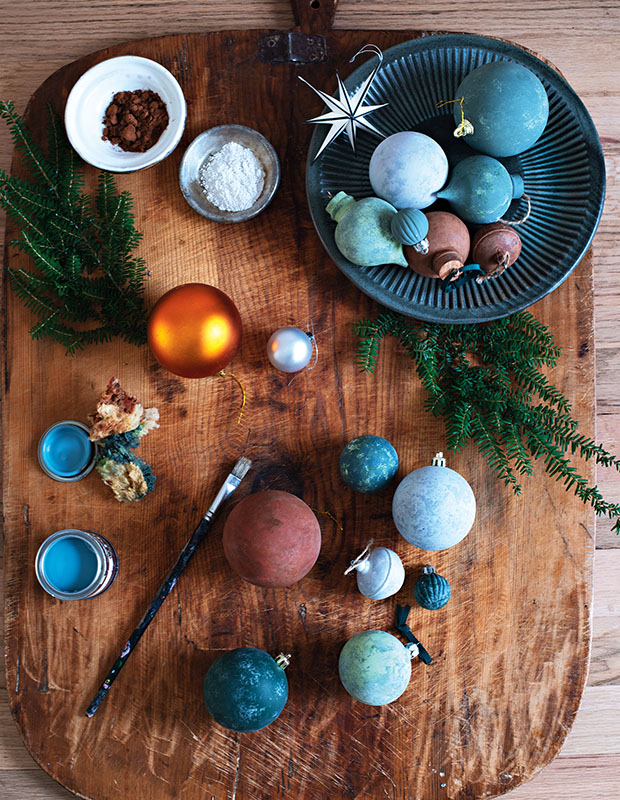 A photograph of a holiday craft: ball-shaped ornaments sit on a wooden cutting board.